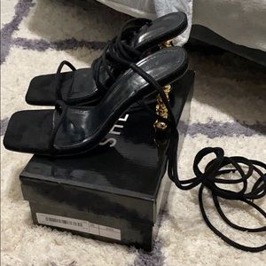 Black strappy shoe with gold heel detail